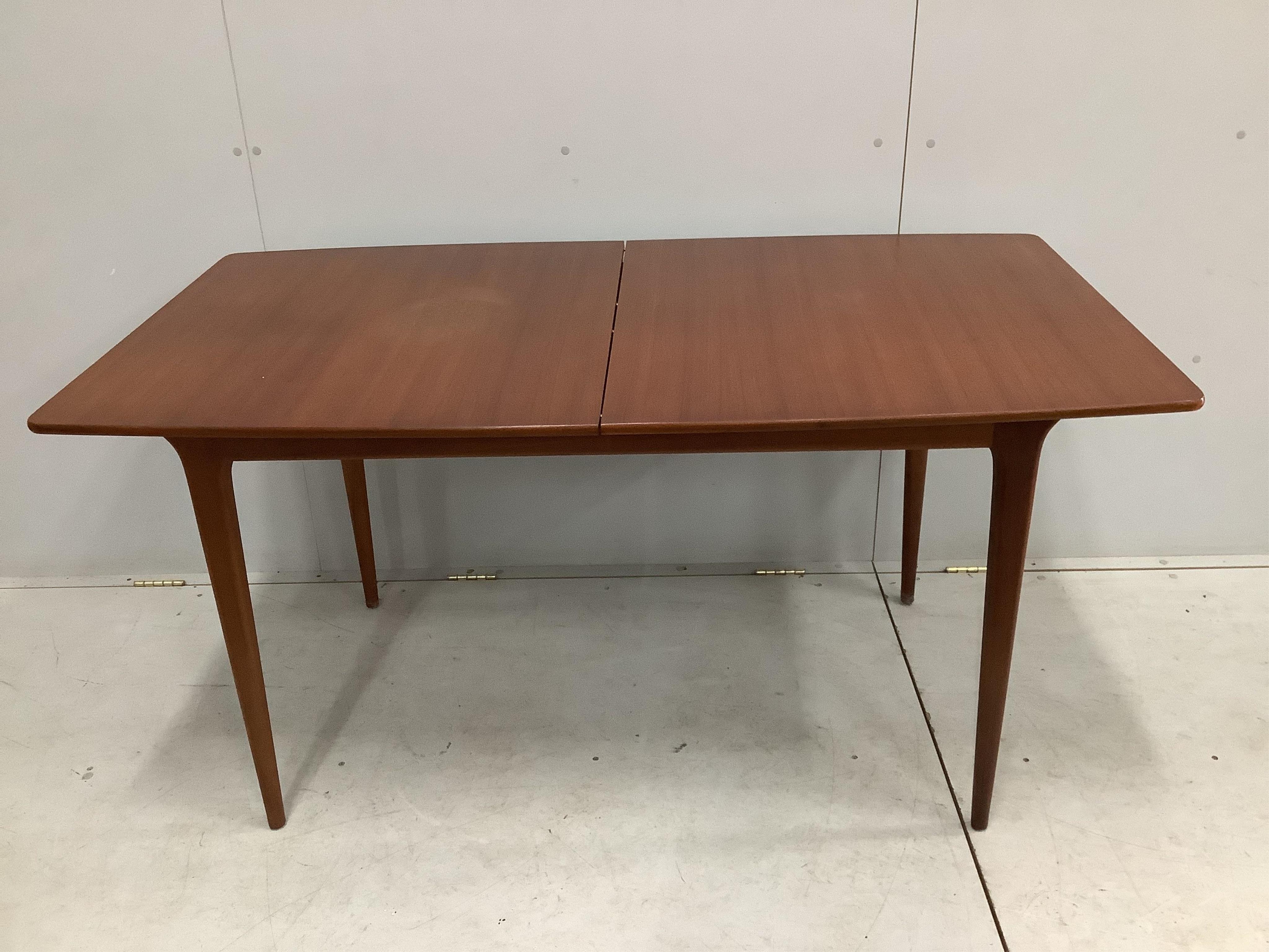 A mid century McIntosh teak extending dining table, width 150cm, depth 82cm, height 74cm together with four chairs, and a low sideboard. Condition - fair to good